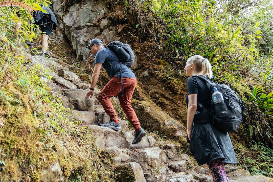 Climbing a steep staircase on the inca trail to machu picchu