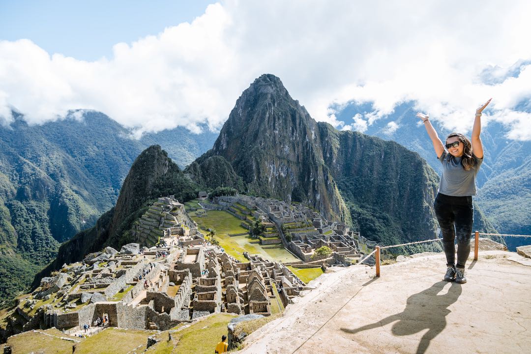 Woman hikers climbs a mountain on the grass track. Hiking