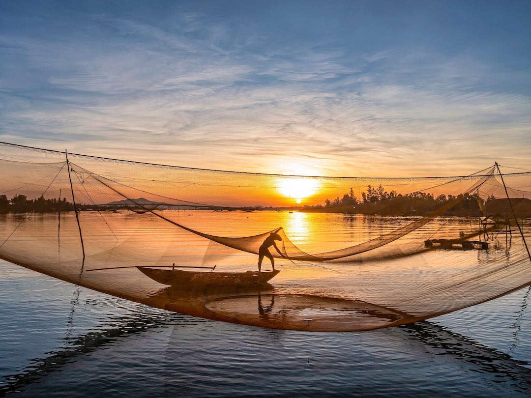 Fisherman on the river of Vietnam spotted during our group tour of vietnam and cambodia