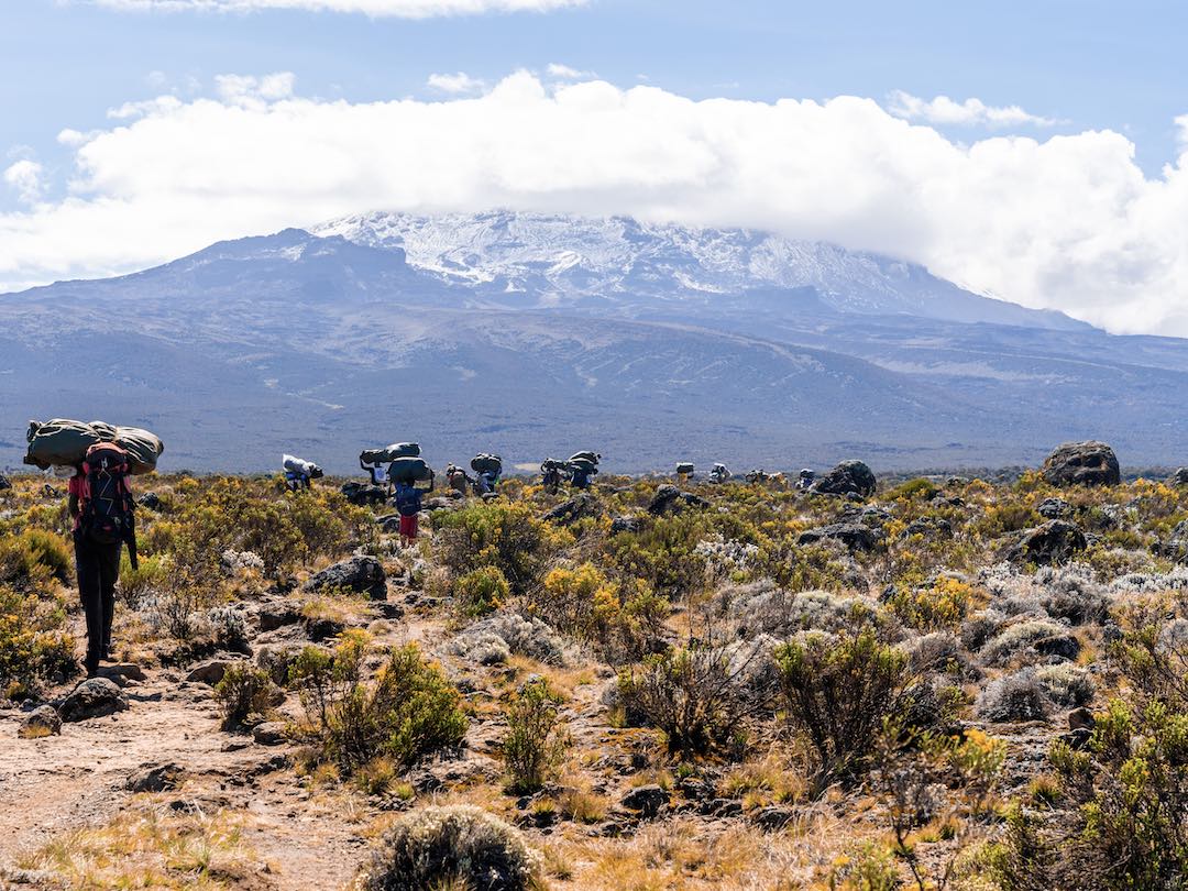 Group of trekkers and view of Mount Kilimanjaro during the Kenya & Tanzania group tour