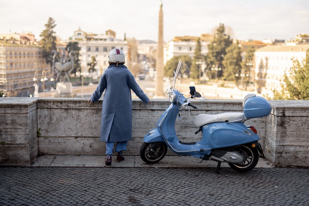 A girl and a vespa in Rome, during an Italy group tour with Other Way Round Travel