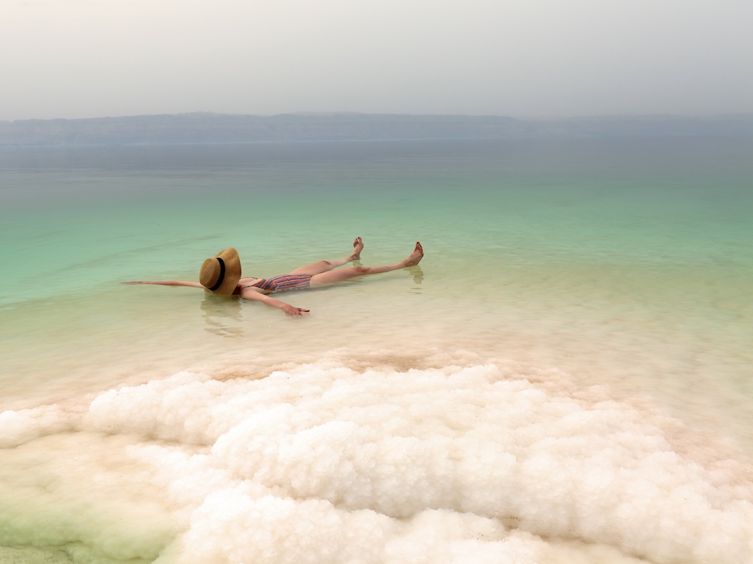 Woman floating in the Dead Sea during the Jordan group tour with Other Way Round Travel