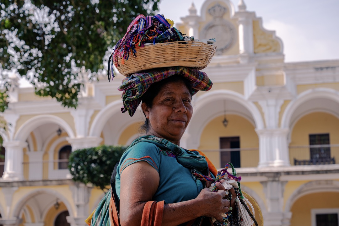 Indigenous Guatemalan woman selling crafts in Antigua  during the Guatemala & Belize group tour with Other Way Round Travel