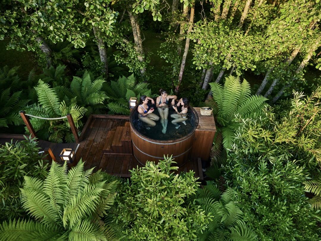 Enjoying forest hot tubs on the New Zealand group tour with Other Way Round Travel