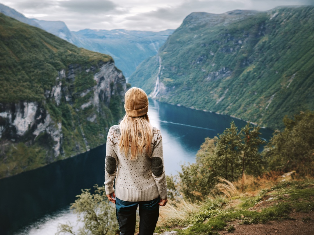 A lady overseeing a fjord in Norway during the Other Way Round Travel group tour of Scandinavia