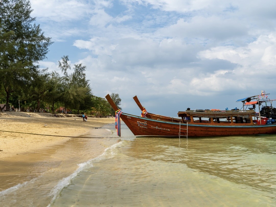 Island-hopping with a long tail boat during Thailand group tour